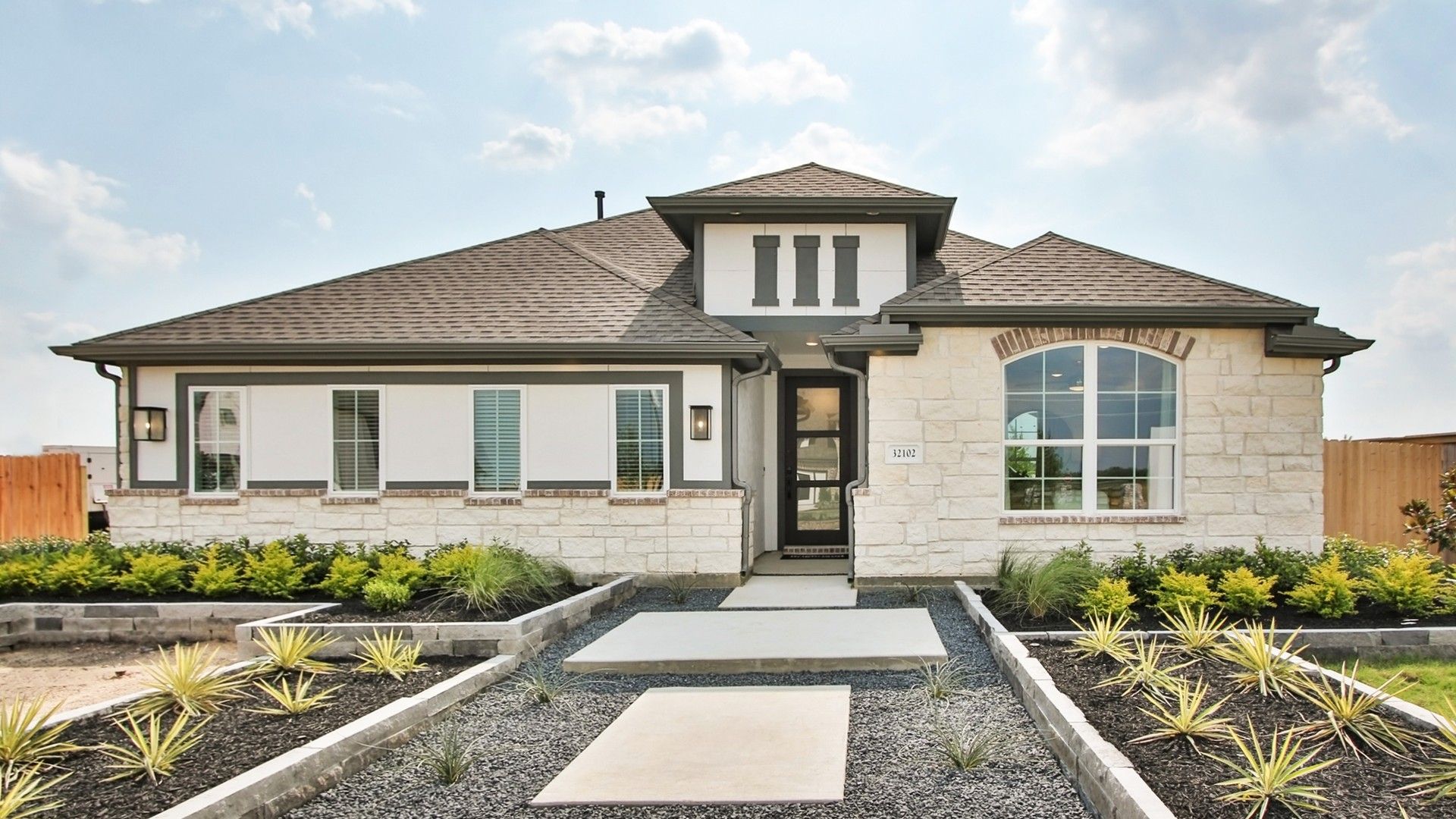Discover refined elegance with a stone facade and arched windows, nestled in Oakwood Estates.