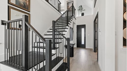 Experience refined elegance with sleek dark wood stairs and railings. Park at Eldridge.