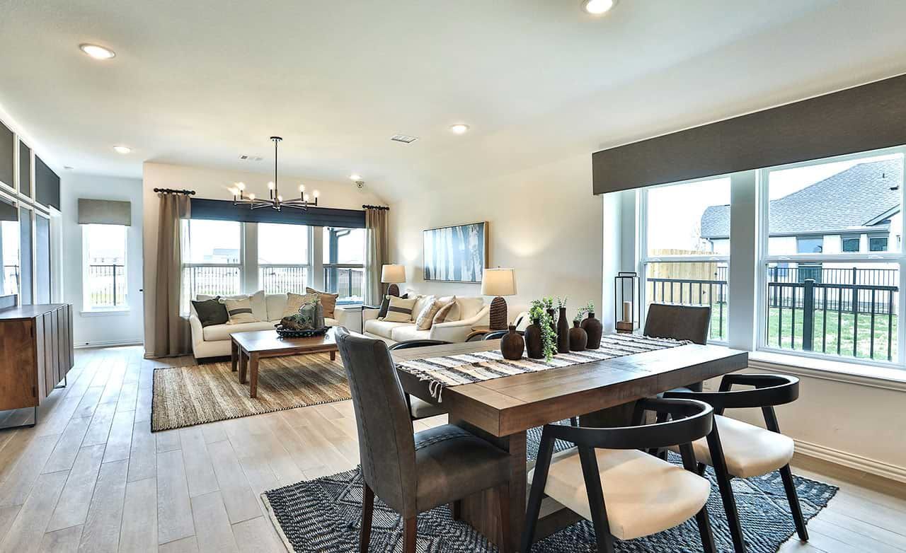 Luxurious open-concept space with expansive windows, sleek wood flooring, and elegant fixtures in Bridgeland, Cypress.