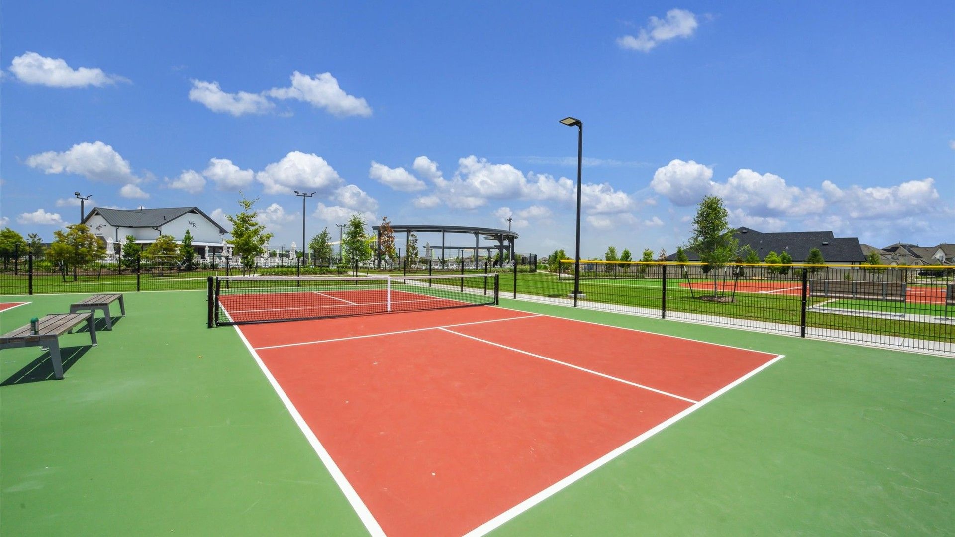 Experience refined leisure at Westland Ranch; modern tennis courts boast premium finishes amid lush surroundings.