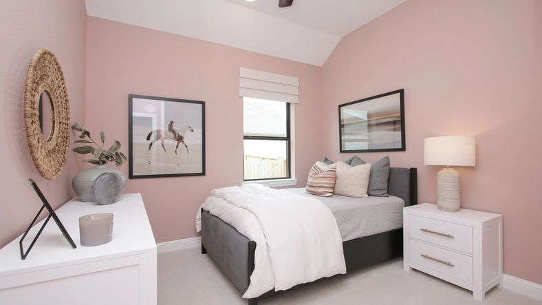 Luxurious bedroom featuring soft pink walls and tasteful decor, set in the esteemed Coastal Point community.