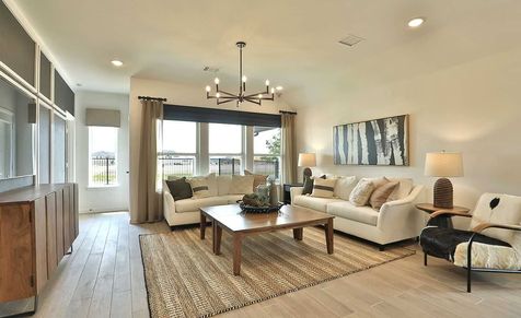 Exquisite wood flooring and chic furnishings adorn this Bridgeland living room.