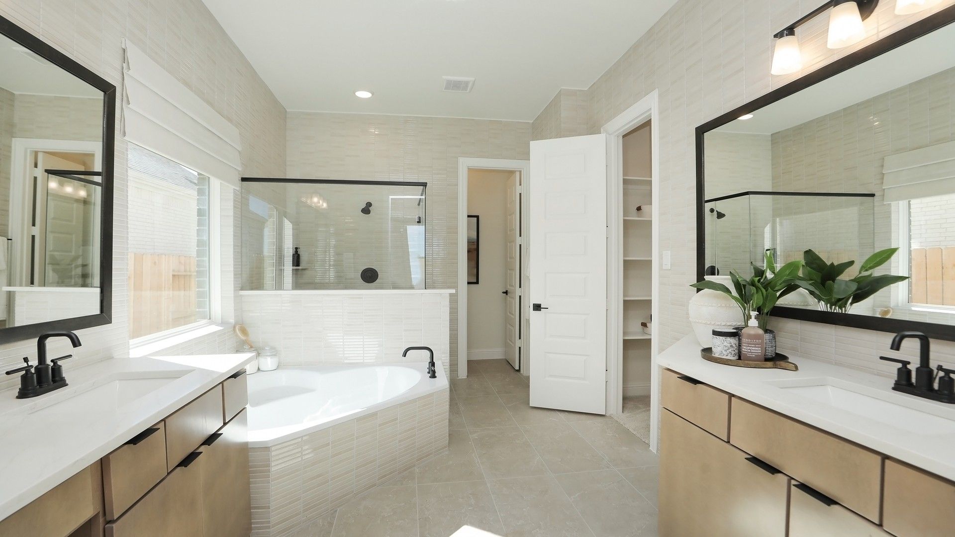 Luxurious Brookewater bathroom with marble tiles, dual vanity, and frameless glass shower. Opulent design elements.