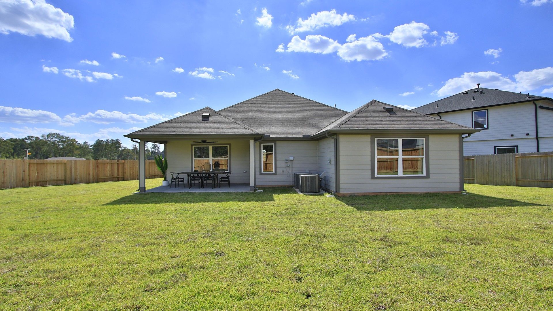 Enjoy a serene outdoor retreat with a covered patio and expansive lawn in beautiful Cielo.