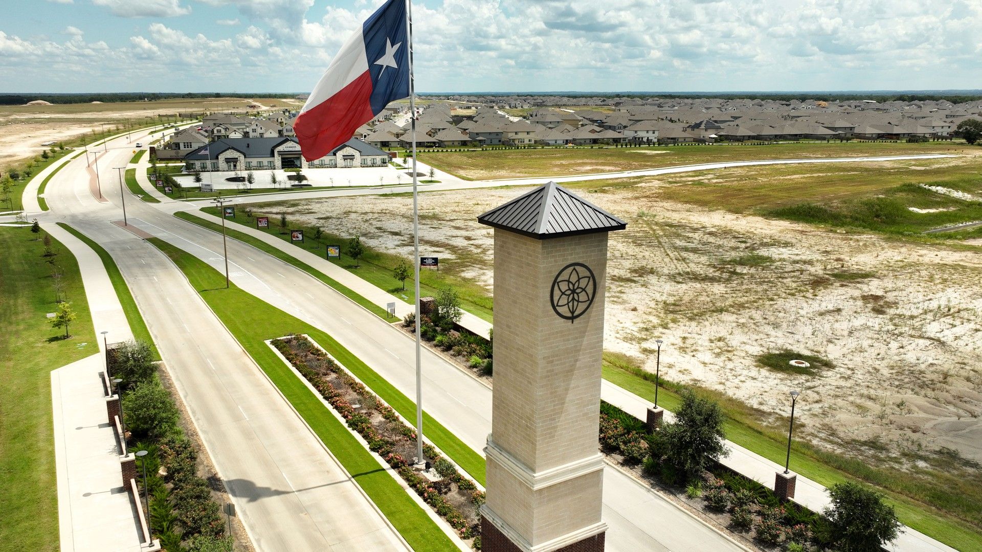 Elegant tower and Texas flag mark Southern Pointe's entrance in College Station, Texas.