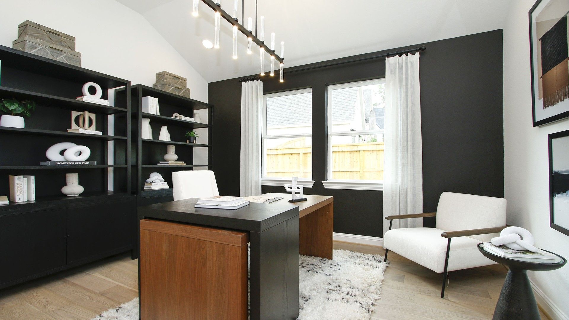Experience sophistication with black shelves, sleek wood desk, and elegant decor in The Woodlands Hills.