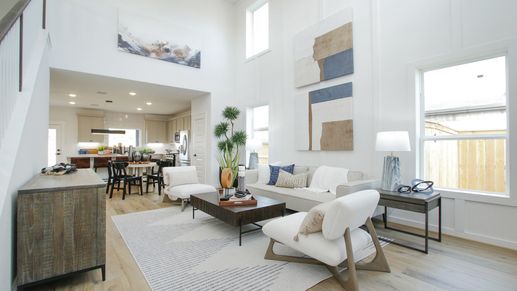 Expansive ceilings, elegant wood floors, and abstract art define this modern space in Colony at Pinehurst.