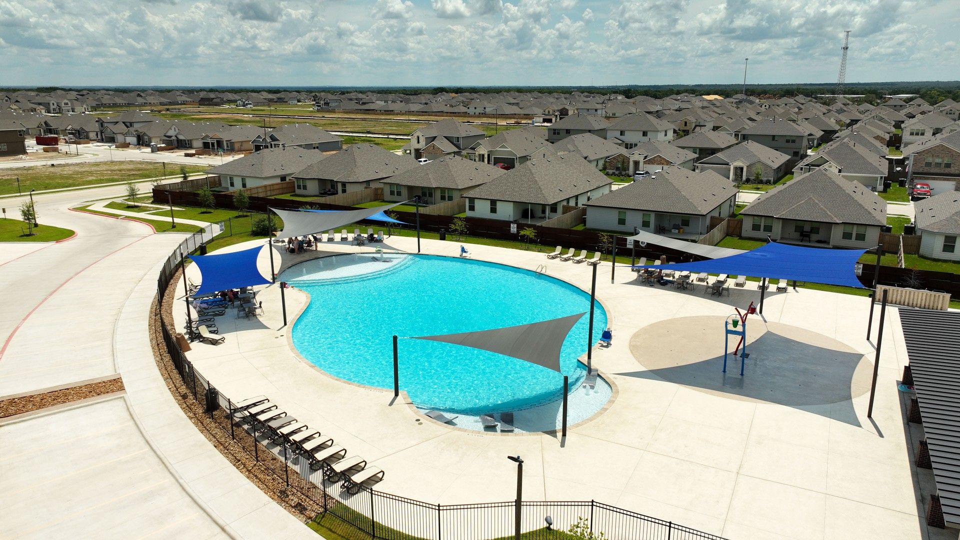 Elegant pool with stylish shade sails in Southern Pointe, College Station, offering luxury leisure.