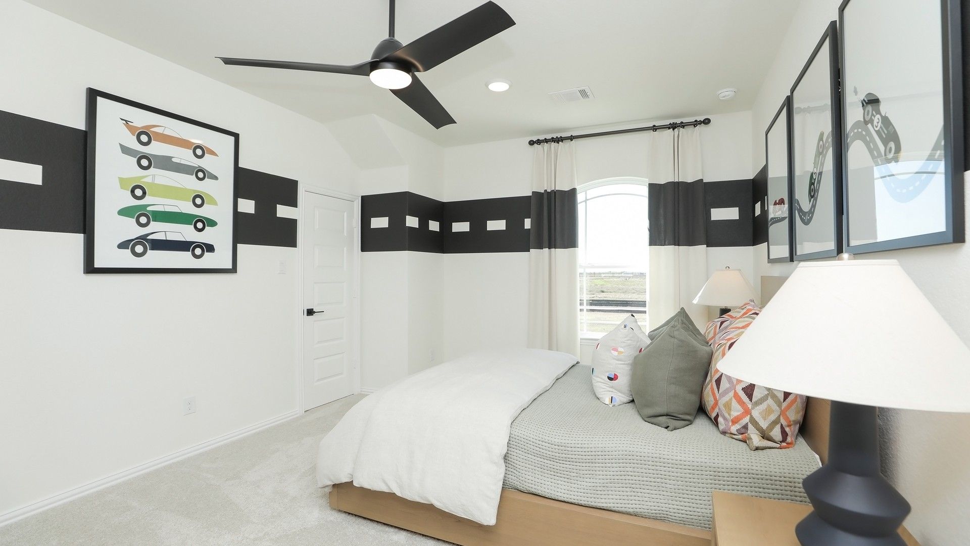 Sleek design with striking black accents and elegant lighting in Brookewater bedroom.