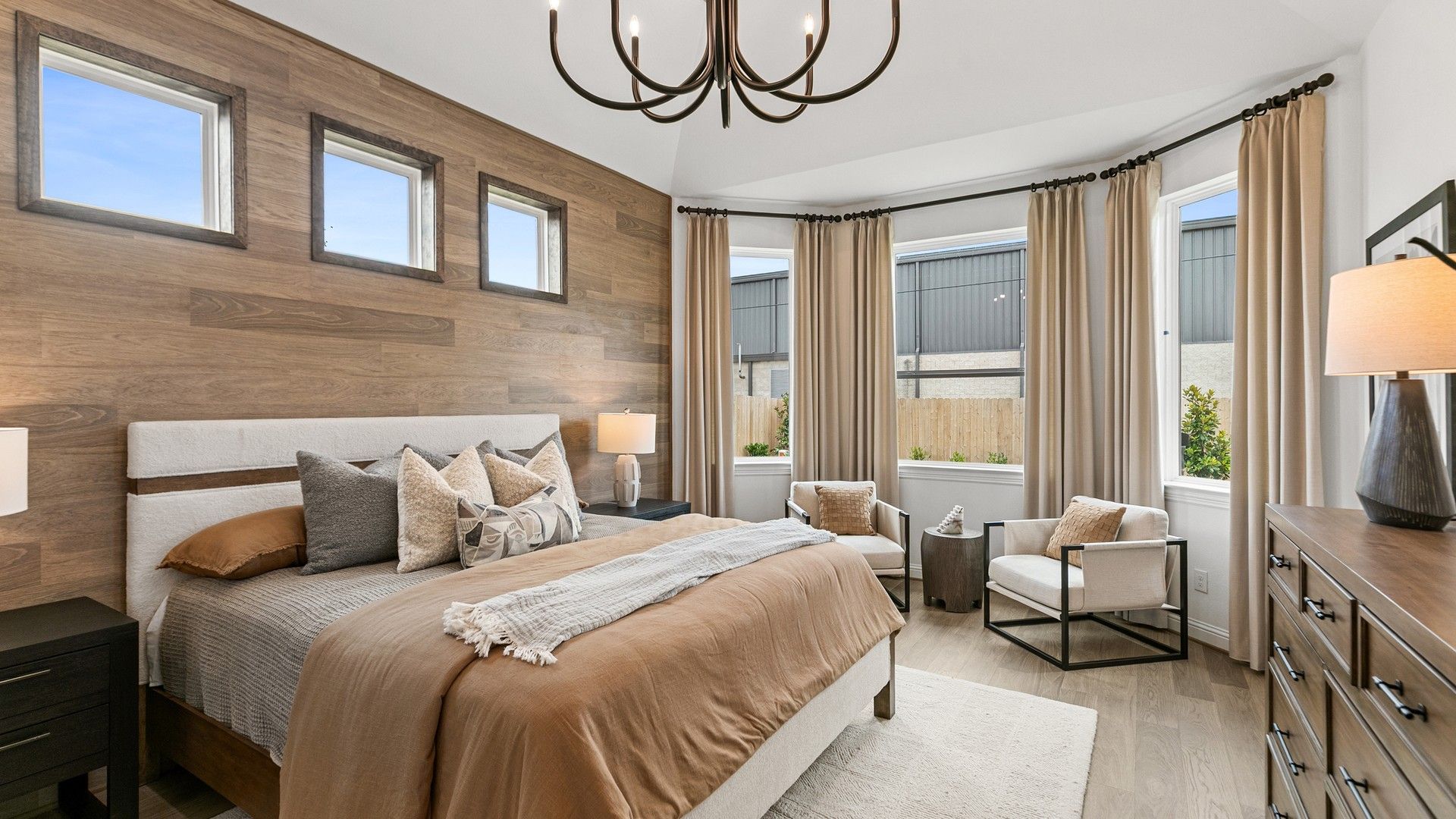 Bask in luxury with wood accents and modern lighting in Beamer Villas’ premier bedroom.