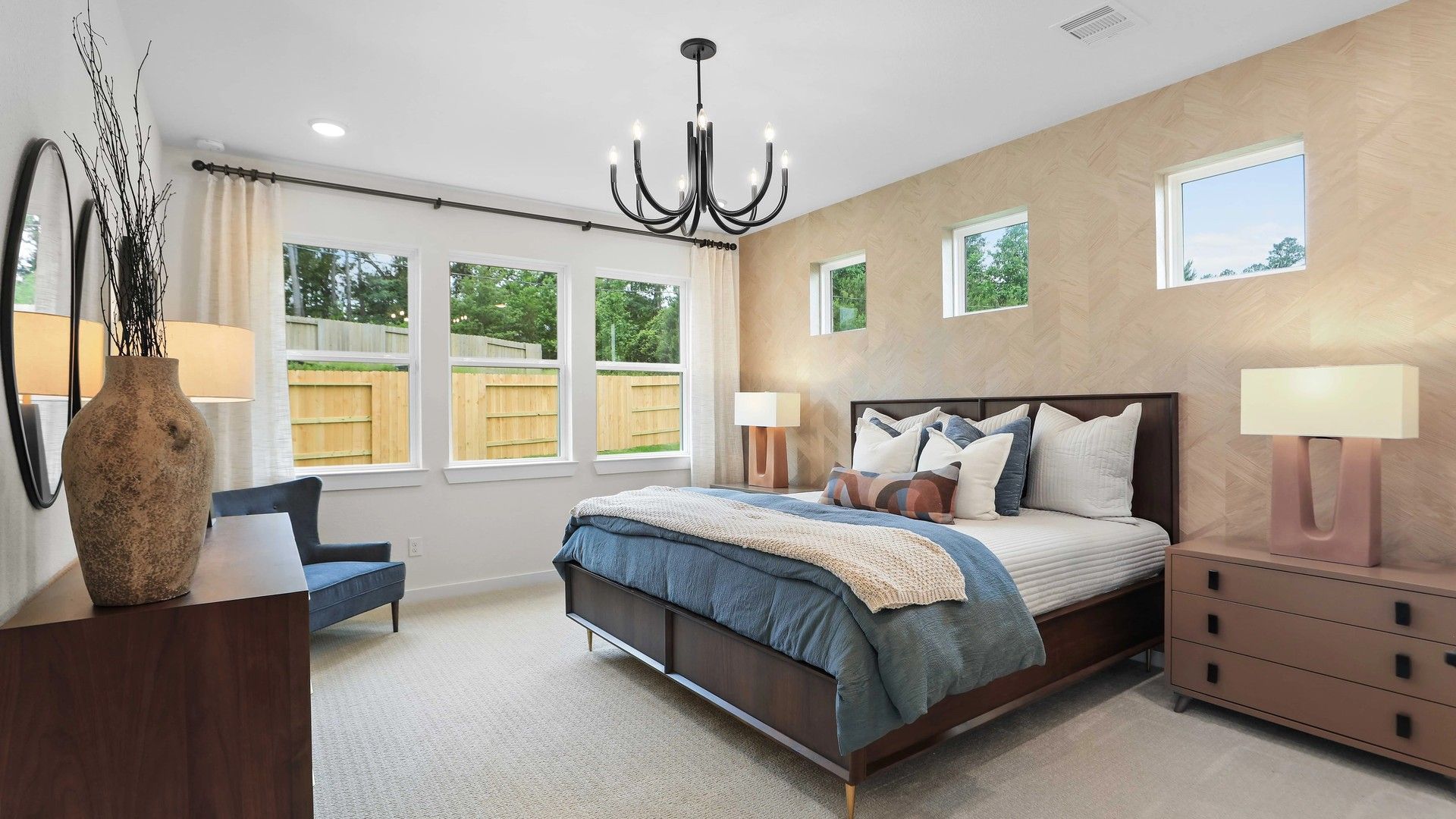 The Mostyn Springs bedroom features designer lighting, custom paneling, and serene views, epitomizing luxury living.