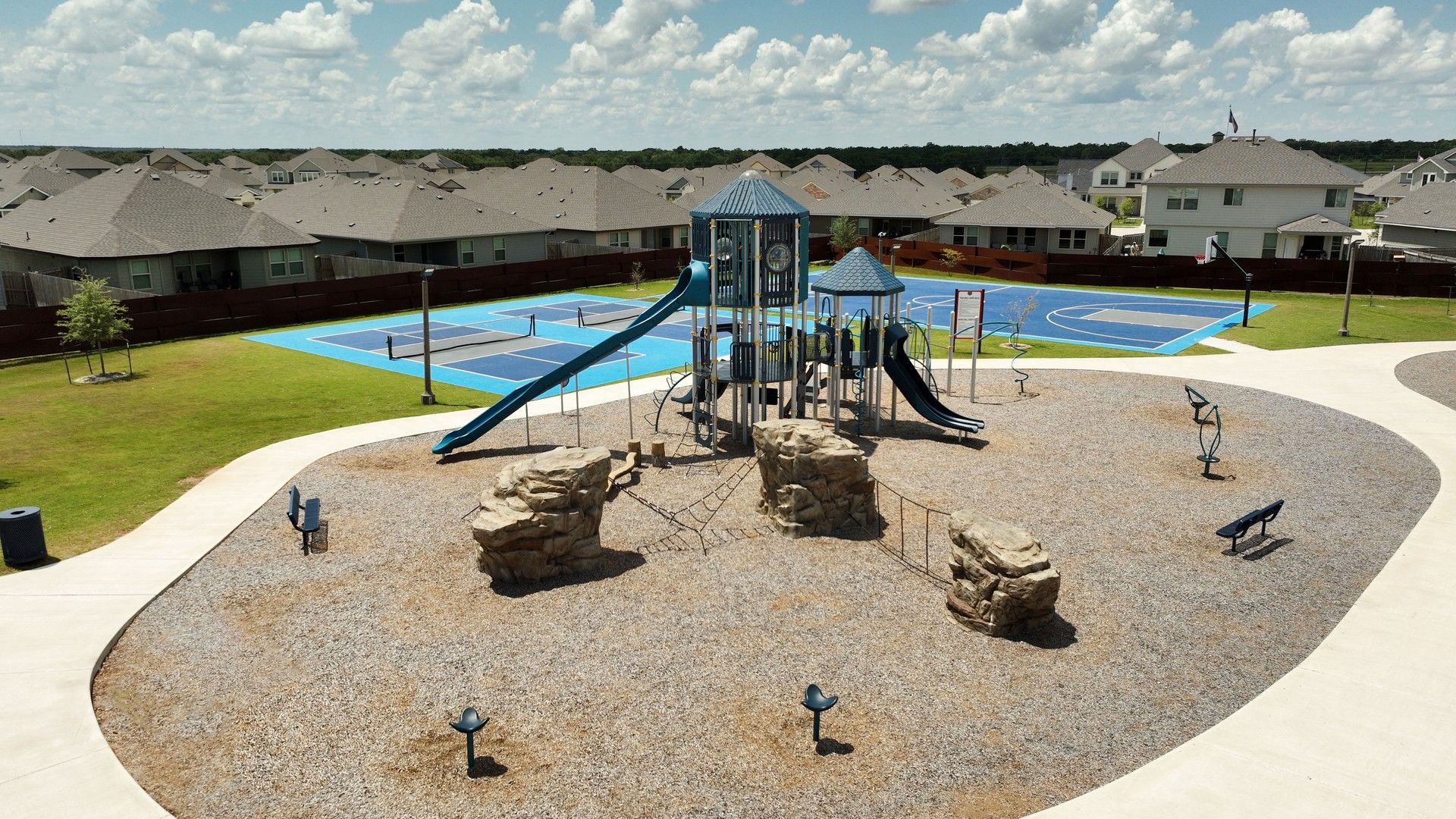 Elegant playground with sleek slides and vibrant sports court in Southern Pointe, College Station.