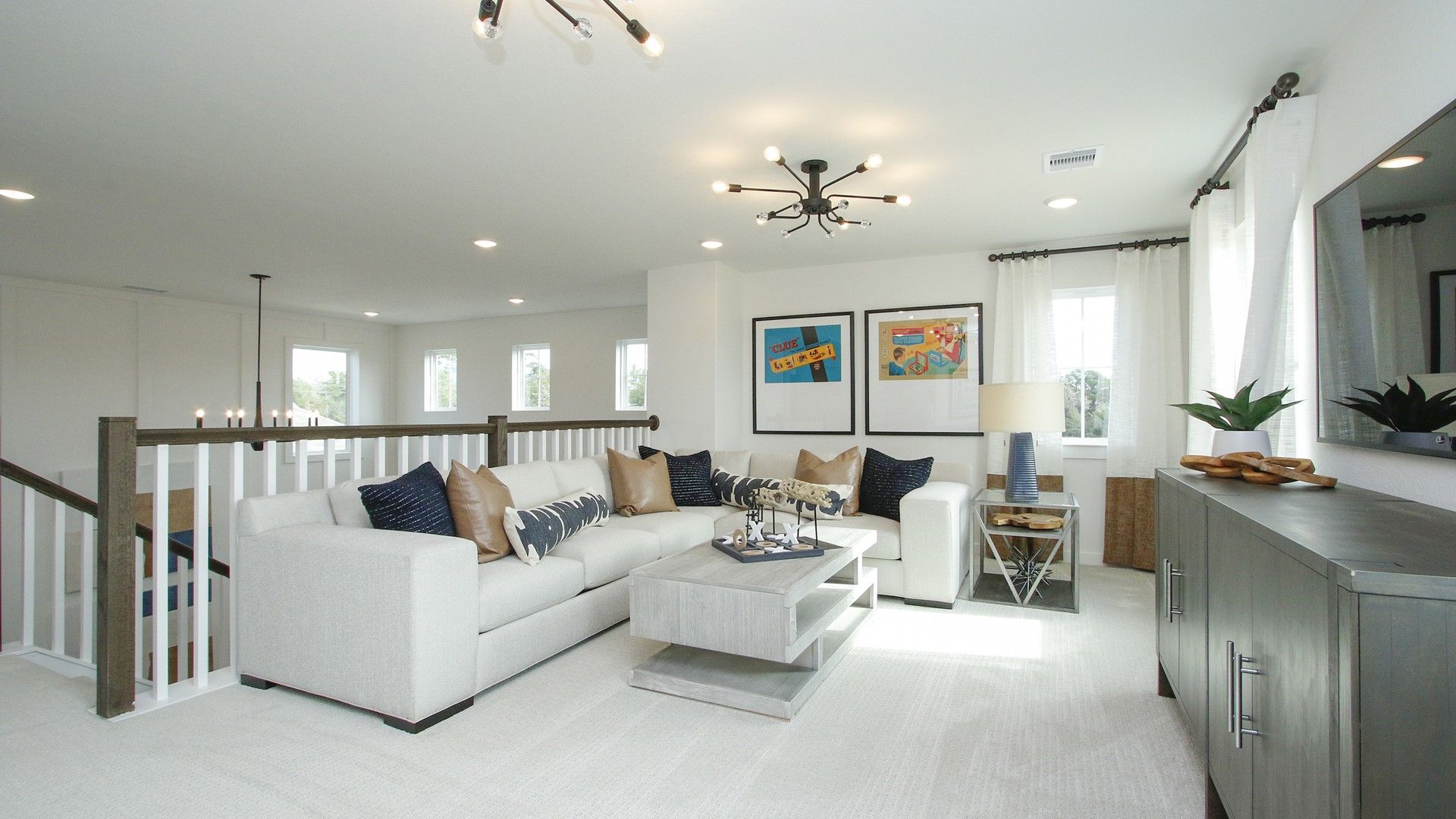 Discover the chic elegance of a spacious living room featuring plush seating, bespoke lighting, and rich textures in Colony at Pinehurst.