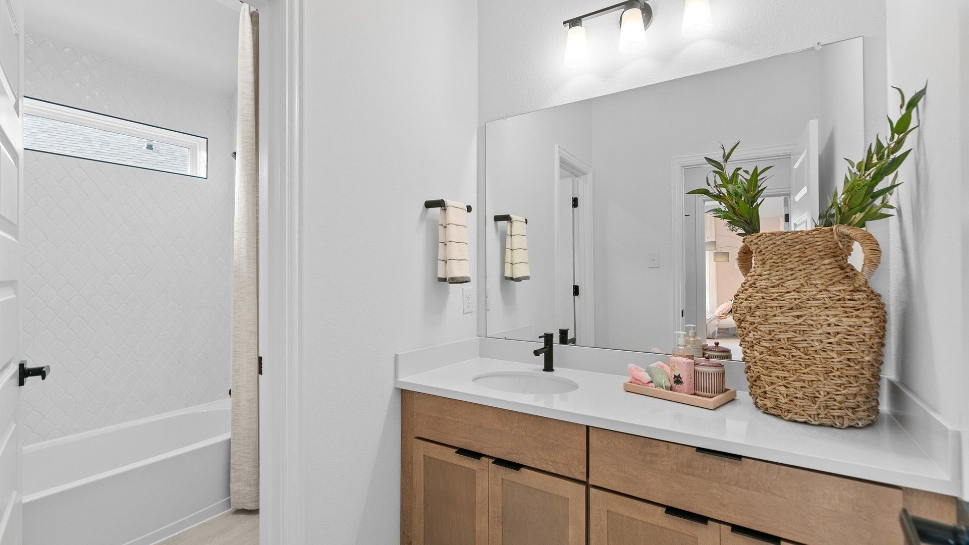 Experience elegance with custom wood vanity and exquisite tile accents in River Ranch.