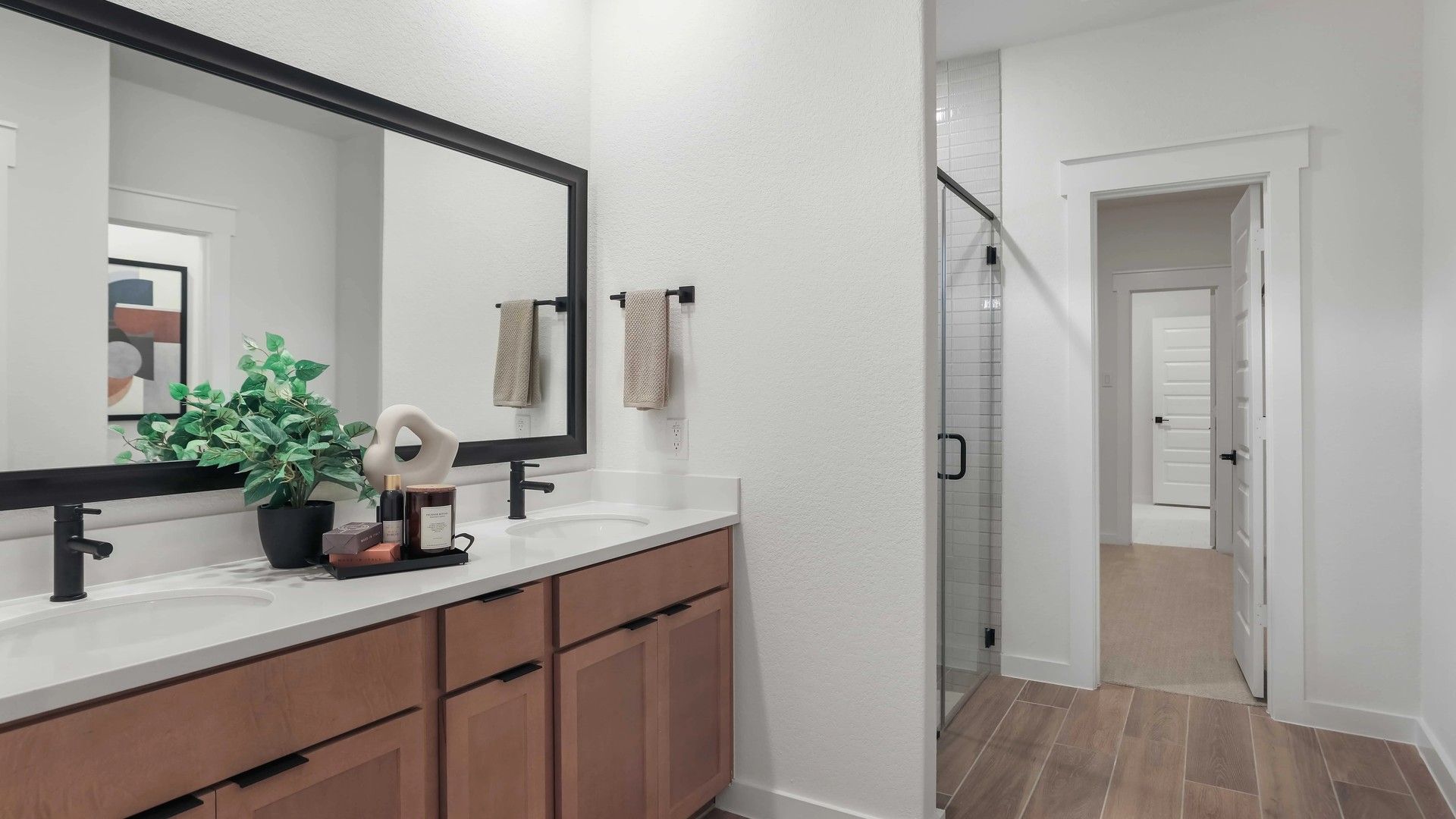 Luxurious wood cabinets and sleek twin sinks enhance bathroom elegance in Mostyn Springs.