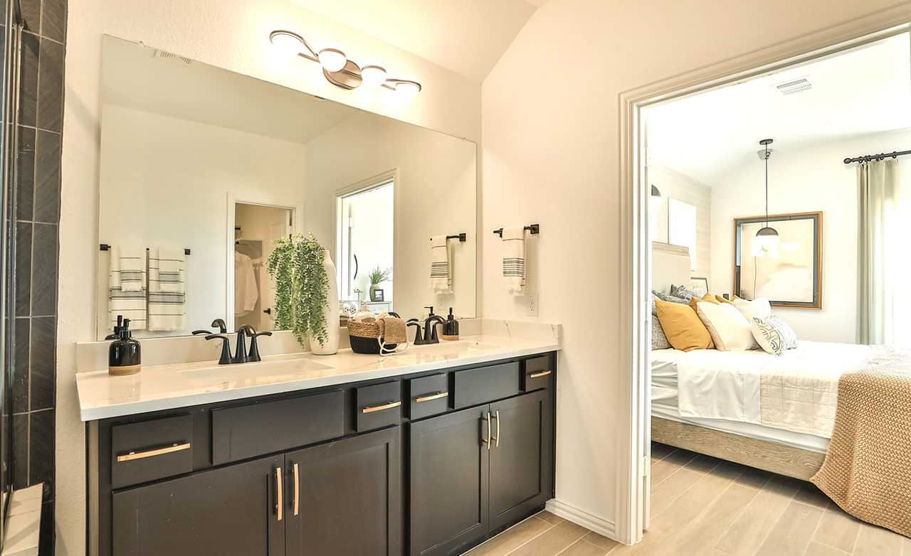 Experience sophistication with a sleek dark vanity and elegant fixtures in Bridgeland's refined residences.