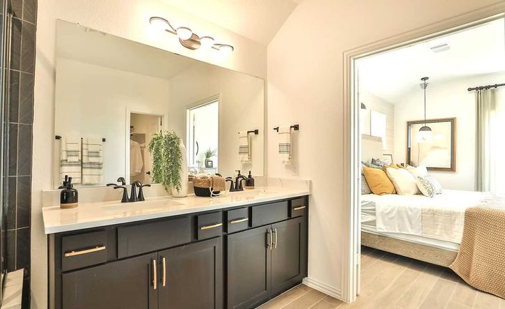 Experience sophistication with a sleek dark vanity and elegant fixtures in Bridgeland's refined residences.