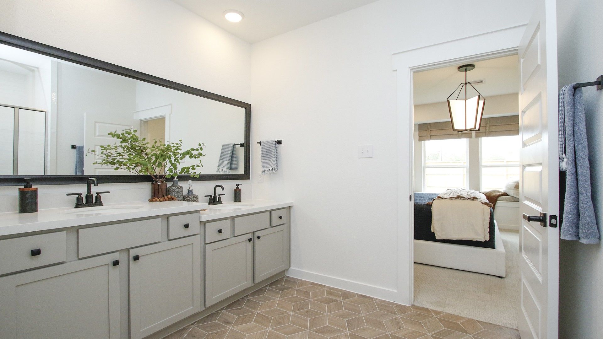 Elegant dual vanity, hexagonal flooring, and refined finishes define this Colony at Pinehurst sanctuary.