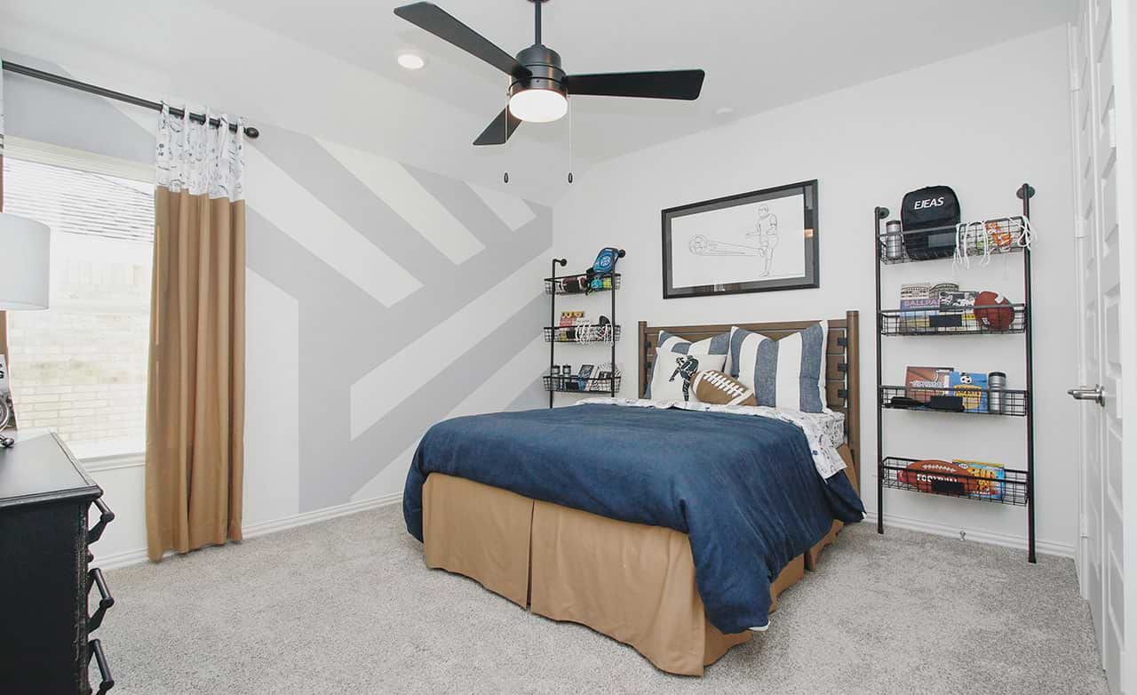 Discover refined comfort in this Cypress Green bedroom with a chic geometric wall and upscale sports accents.