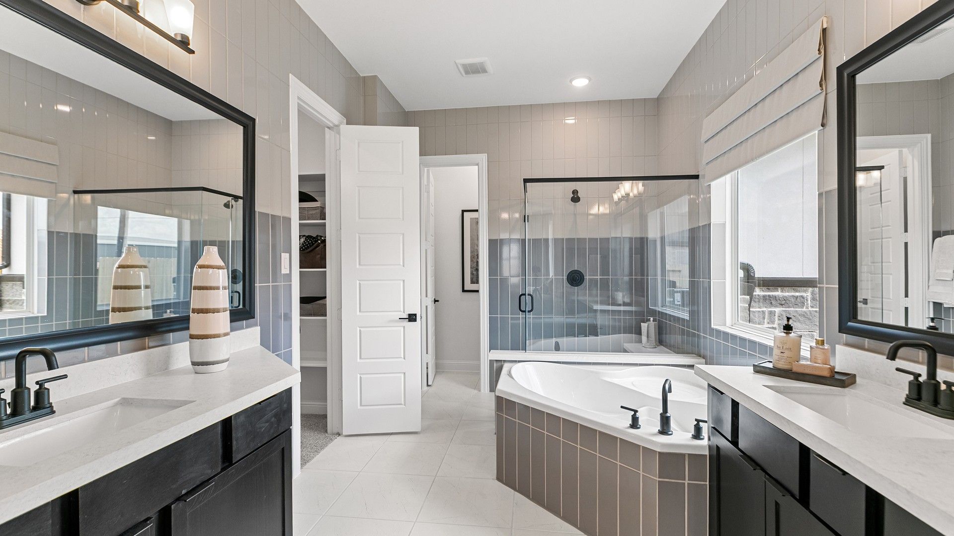 Experience opulence with dual vanities, a soaking tub, and exquisite tiling in Beamer Villas’ luxurious bathroom.