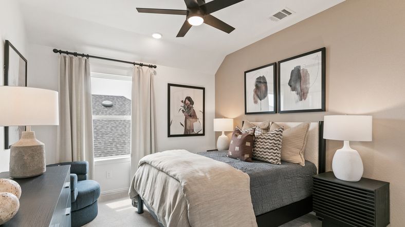 Luxurious bedroom with beige accent wall and plush textiles in Park at Eldridge's exclusive community.