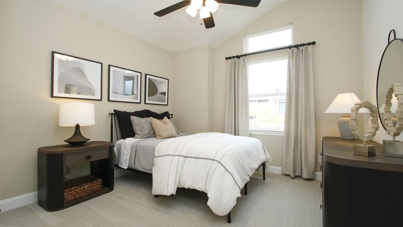 Discover minimalist elegance with high ceilings and sophisticated art in The Woodlands Hills.