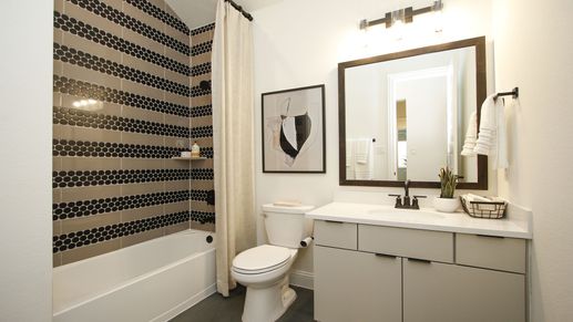 Experience opulence with striking black hexagon tiles and sleek fixtures in The Woodlands Hills.