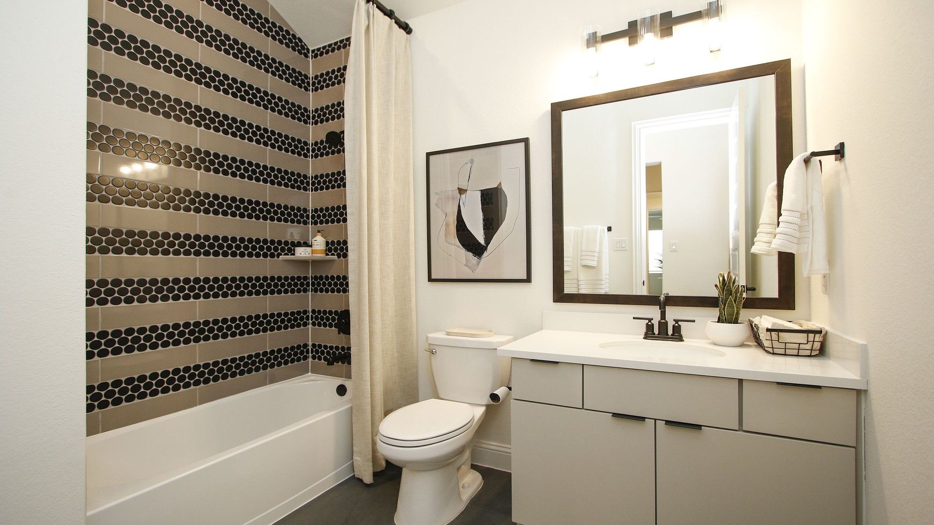 Experience opulence with striking black hexagon tiles and sleek fixtures in The Woodlands Hills.