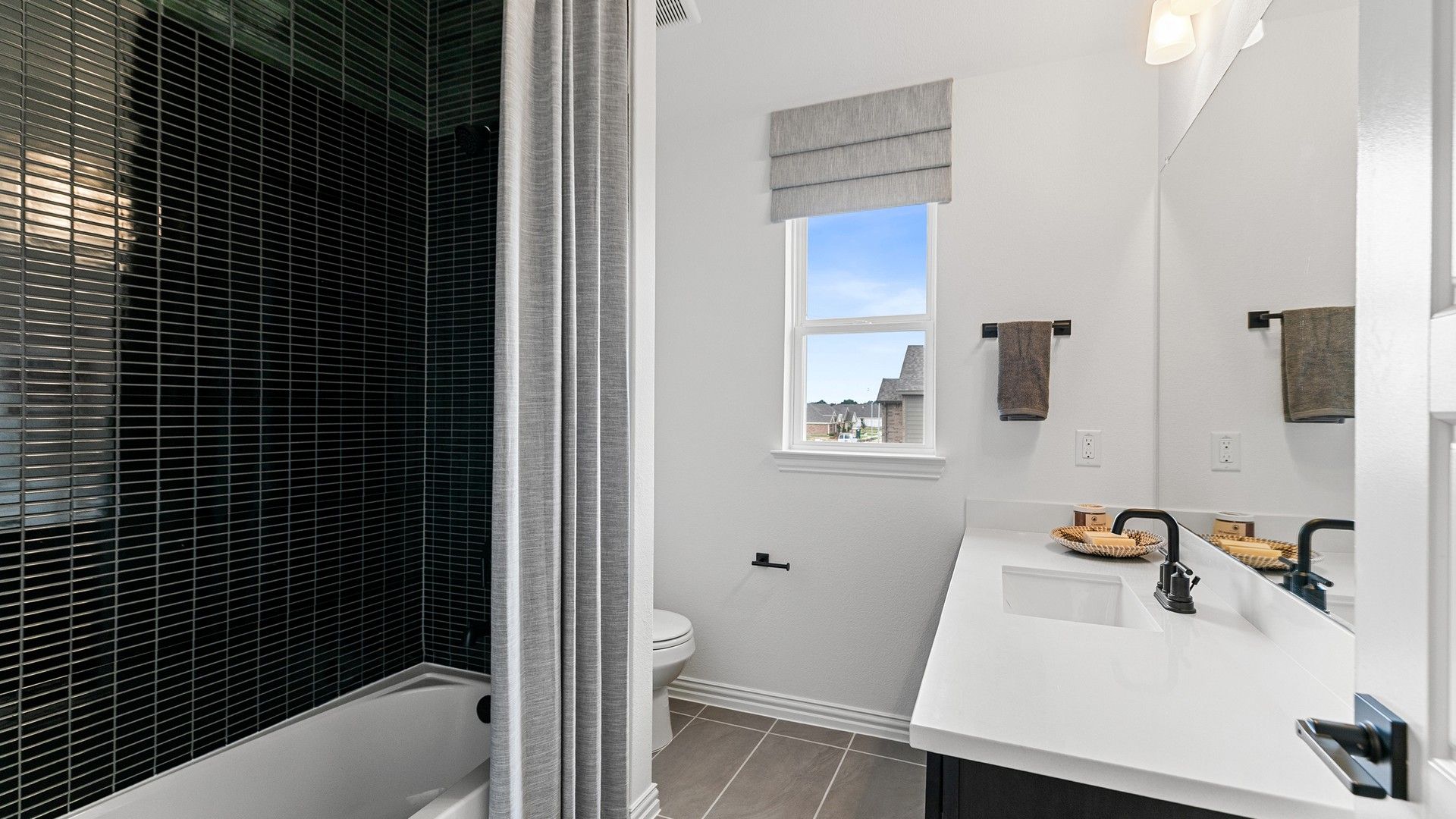 Luxurious bathroom featuring sleek tilework and elegant fixtures. Beamer Villas offers refined living.