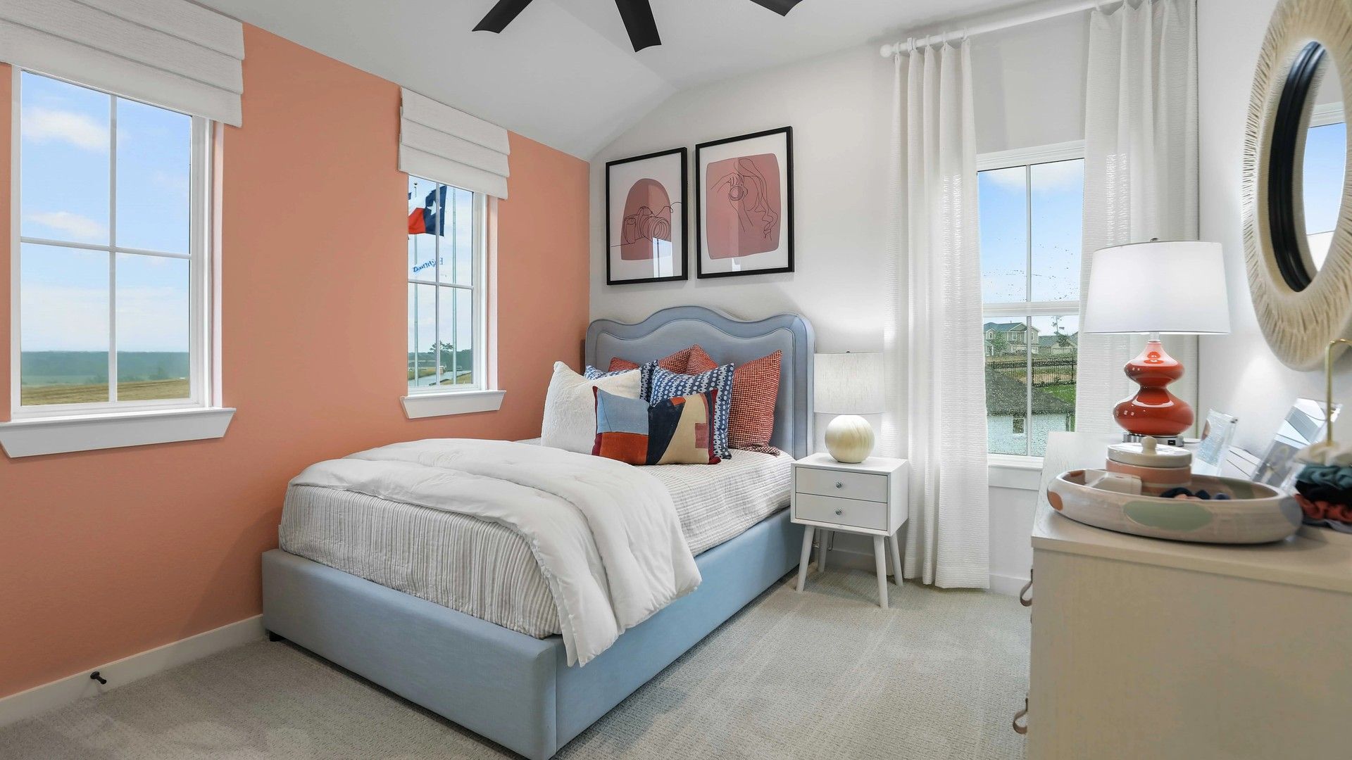 Elegant bedroom with chic coral accents and expansive windows, located in exclusive Mostyn Springs.