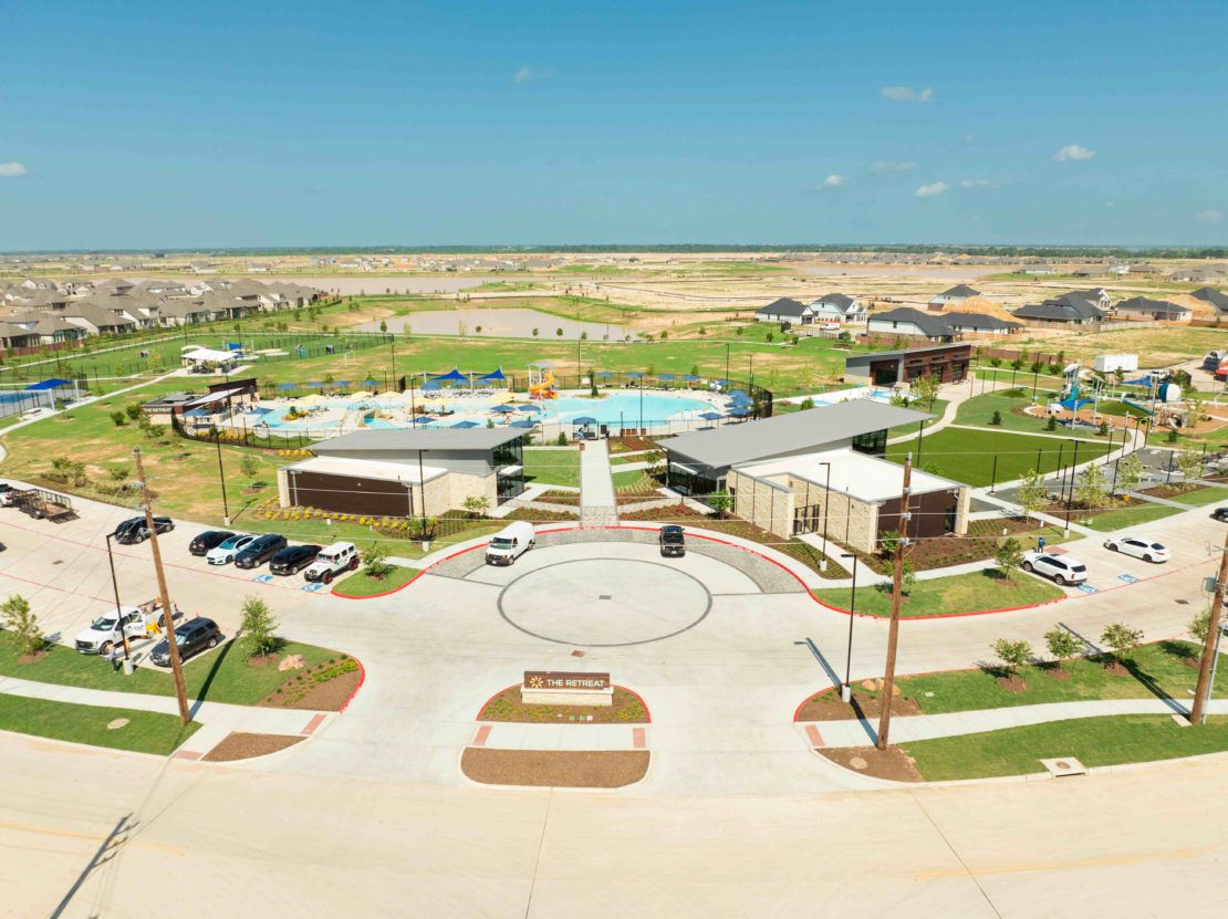 Discover Sunterra's sleek clubhouse and resort-style pool surrounded by lush landscapes, epitomizing luxury.