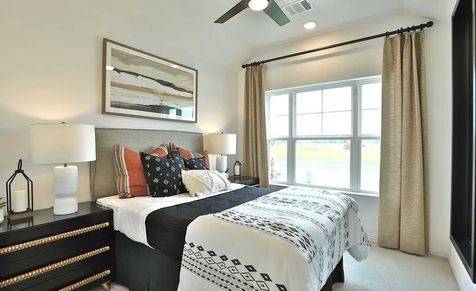 Luxurious bedroom features refined materials, expansive window, and exquisite decor in Bridgeland.