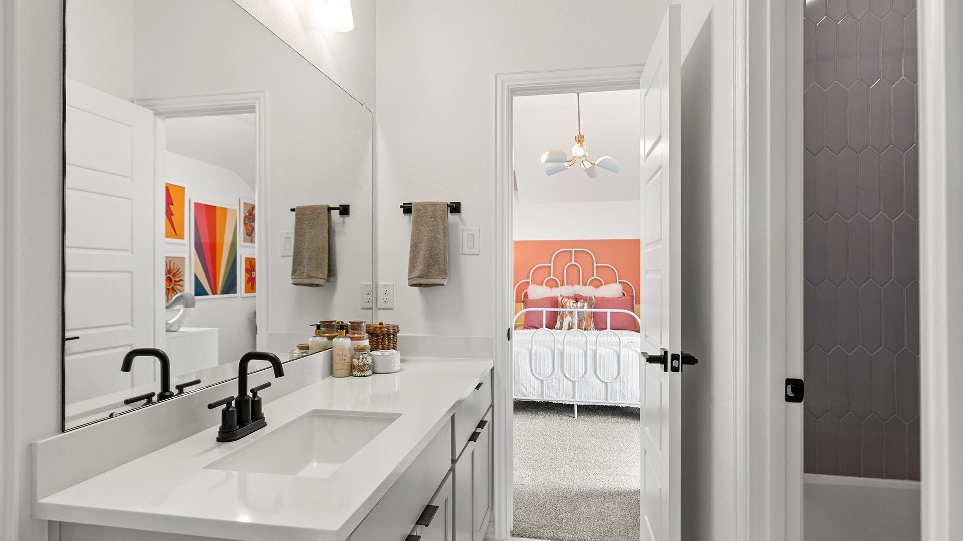 Elegant bathroom boasts sleek black fixtures, hexagonal tiles. Beamer Villas offers refined living.