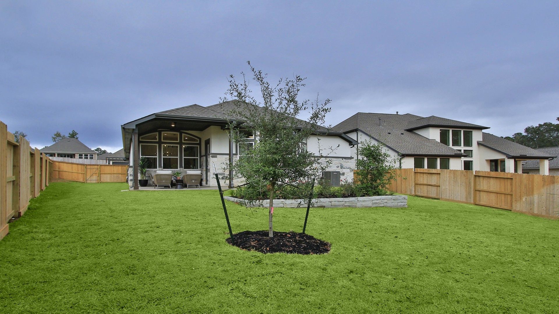 Discover refined elegance with a vast patio and pristine lawn in The Woodlands Hills.