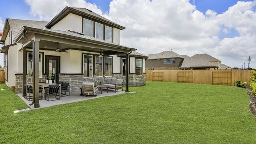 Elegant stone and stucco facade with a chic covered patio. Beamer Villas. Luxurious design elements.