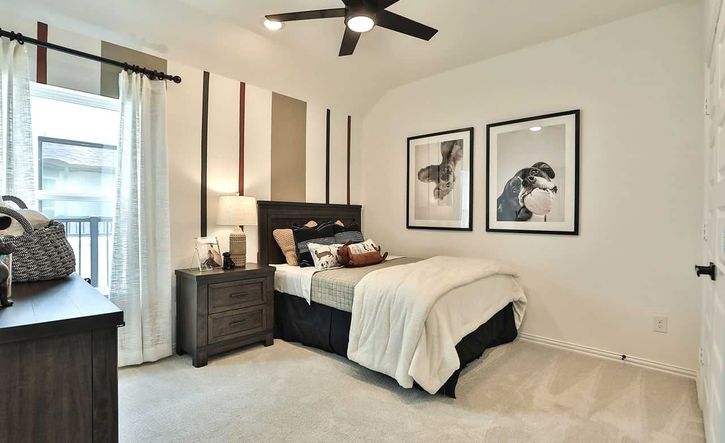Luxuriously designed bedroom with rich wooden accents and chic artwork in Bridgeland, Texas.