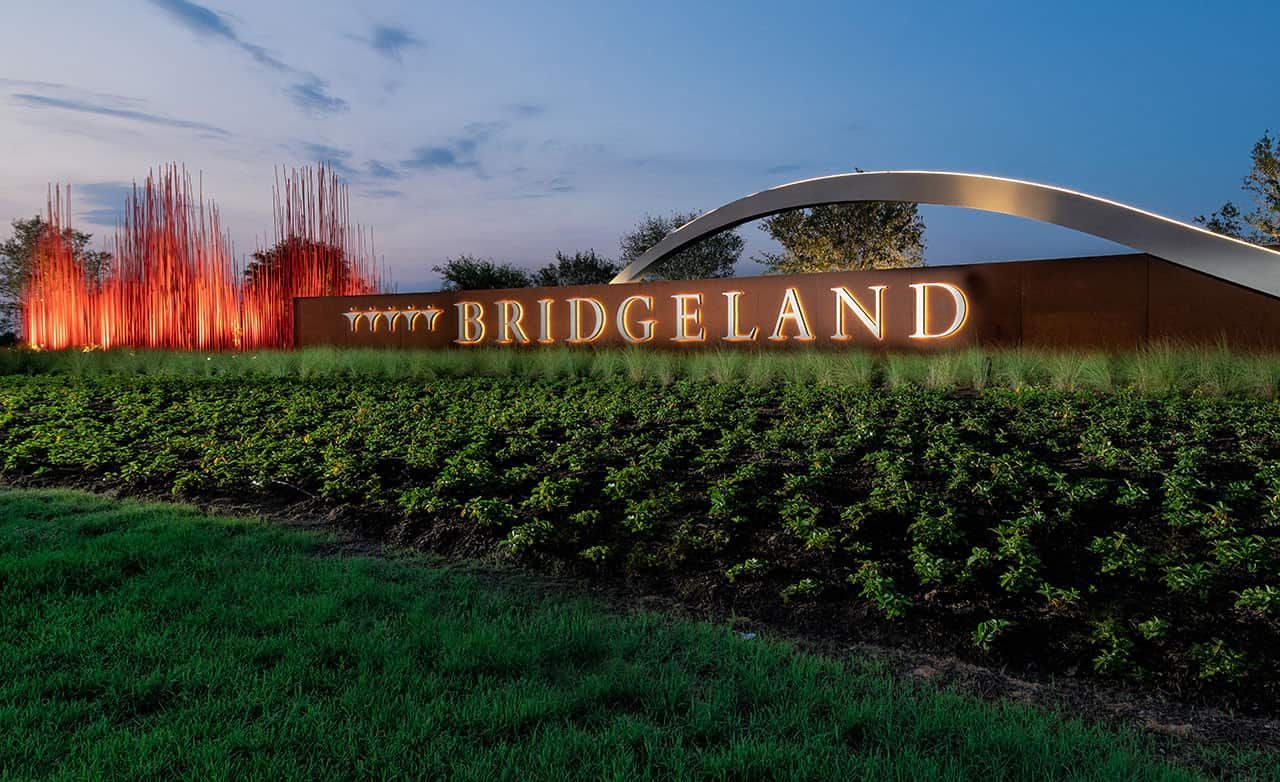 Experience Bridgeland's refined elegance with modern sculptures and a sleek archway in Cypress.