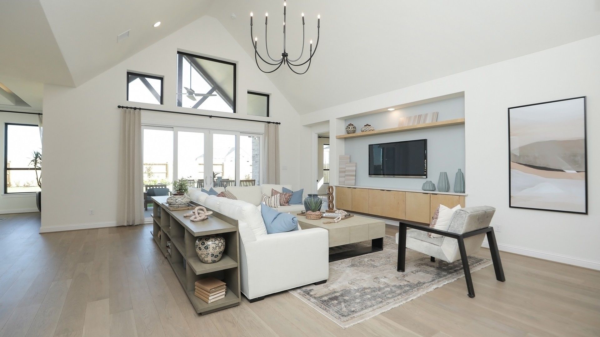 Experience elegant living with vaulted ceilings, chic chandelier, and modern decor in Brookewater.