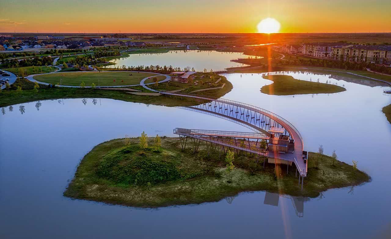 Experience elegant modernity with this arched bridge over tranquil lakes in Bridgeland, Texas.