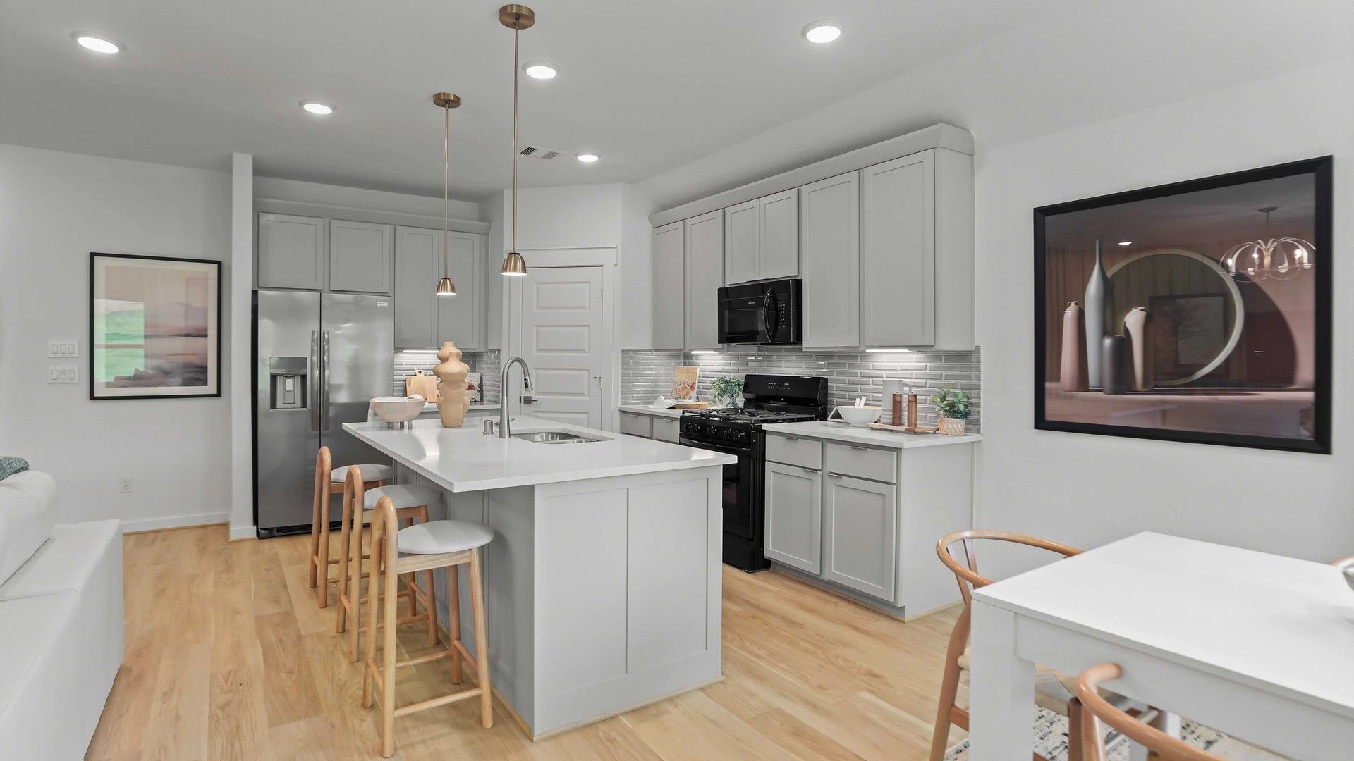 Elegant Mostyn Springs kitchen features sleek cabinetry, quartz island, and refined pendant lighting.