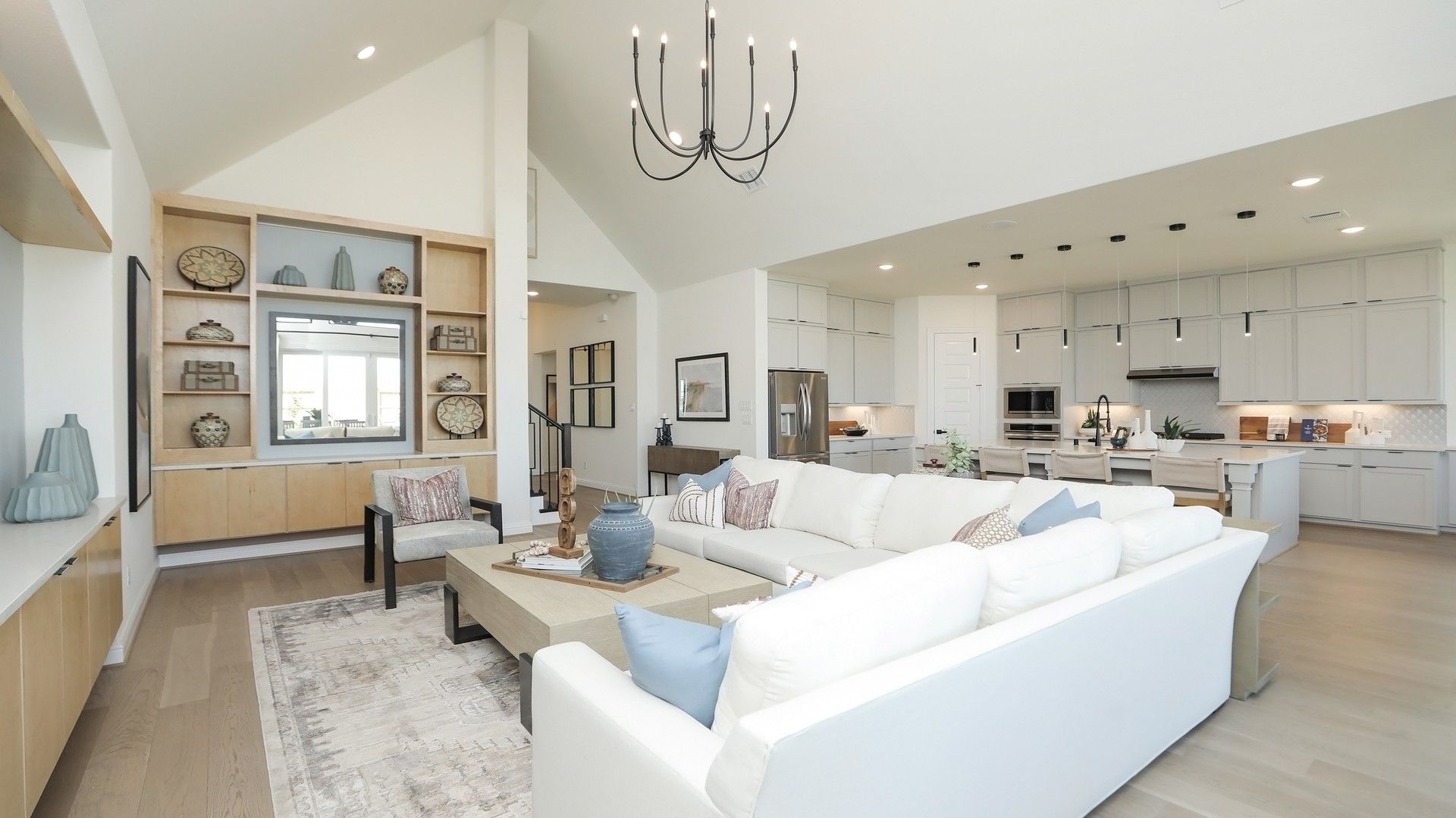 Experience luxury in Brookewater with airy vaulted ceilings and sleek, modern kitchen design.