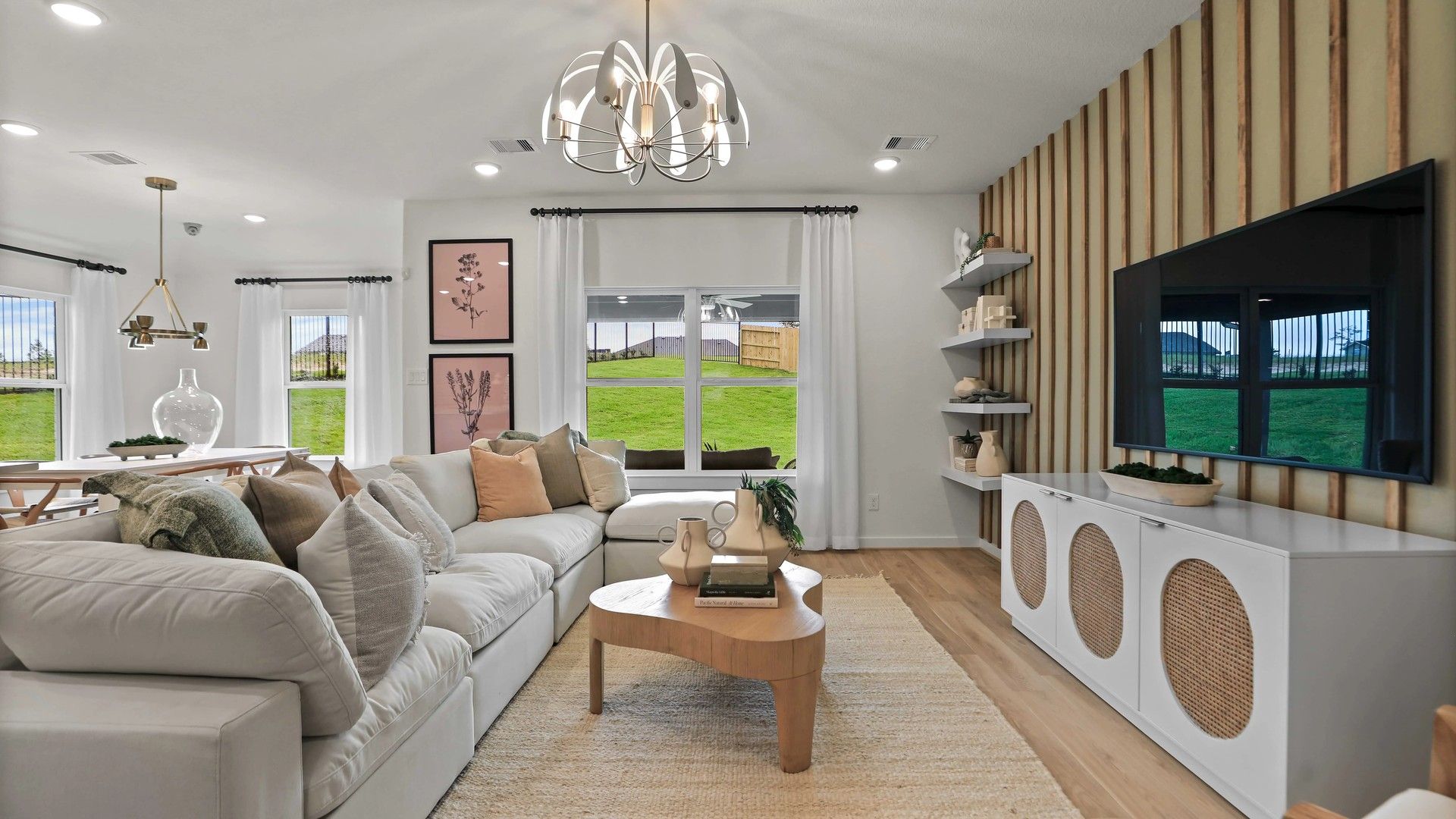 Experience refined living with a plush sofa, sleek accent wall, and designer lighting in Mostyn Springs.