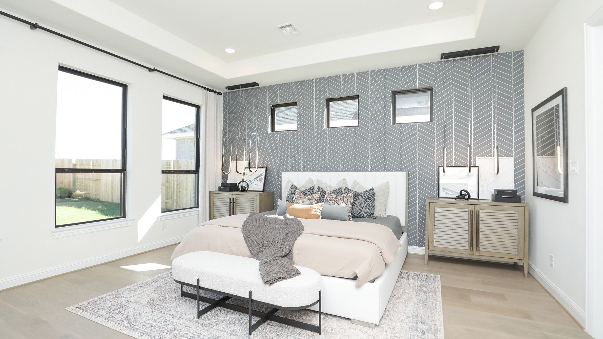 Luxurious room features a striking herringbone accent wall and large windows, exuding elegance in Brookewater.