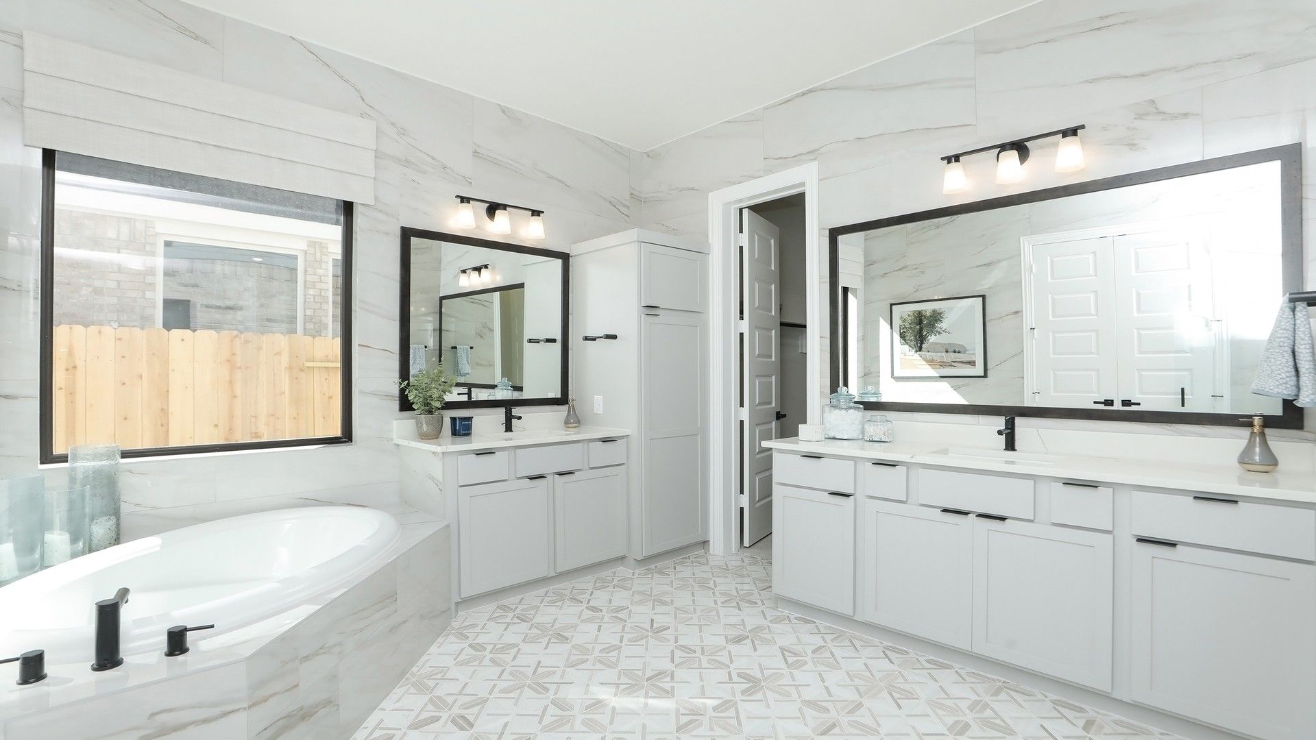 Experience refined luxury with marble tile, dual vanities, and an inviting tub in Brookewater.
