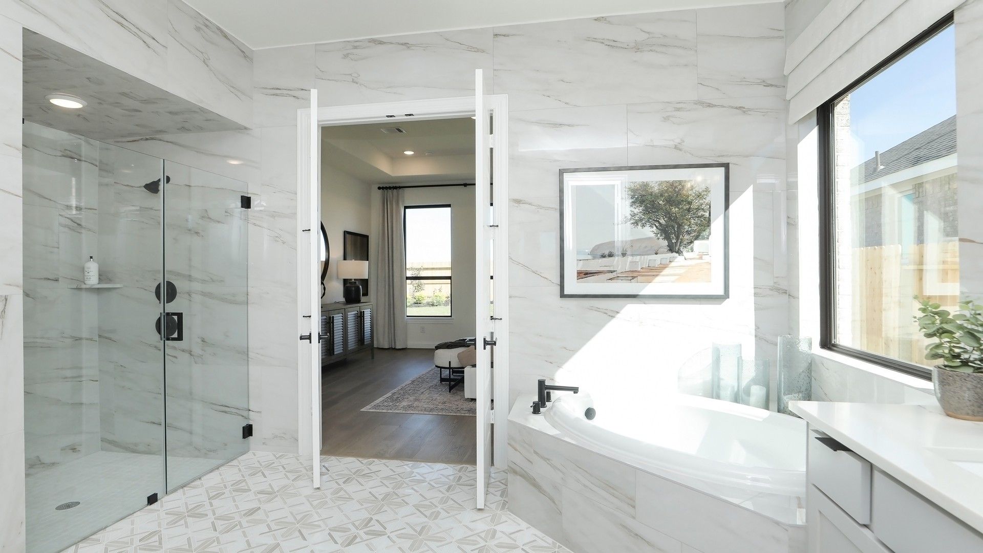 Brookewater's bathroom boasts elegant marble tiles, a luxurious soaking tub, and expansive glass shower.