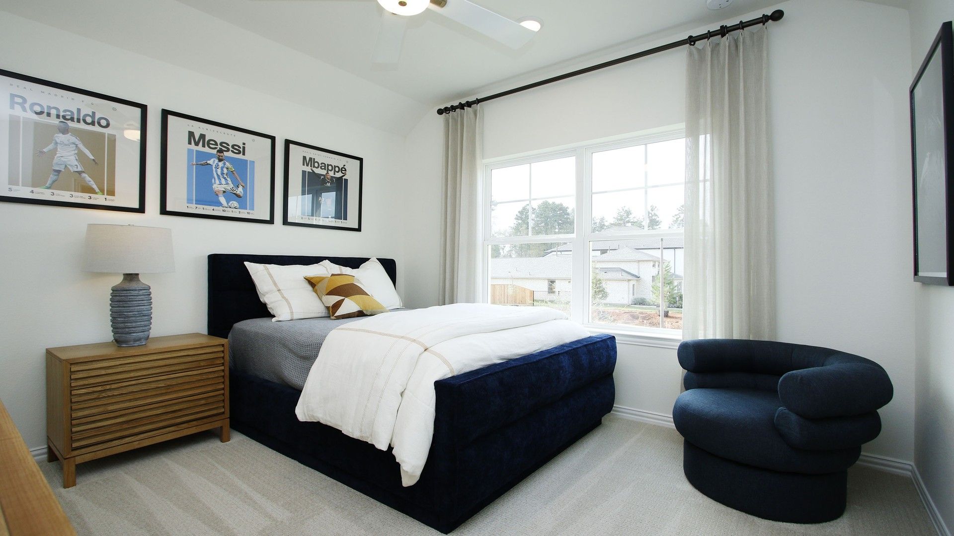 Exquisite navy velvet bed and chic decor elevate luxury in this Woodlands Hills bedroom retreat.