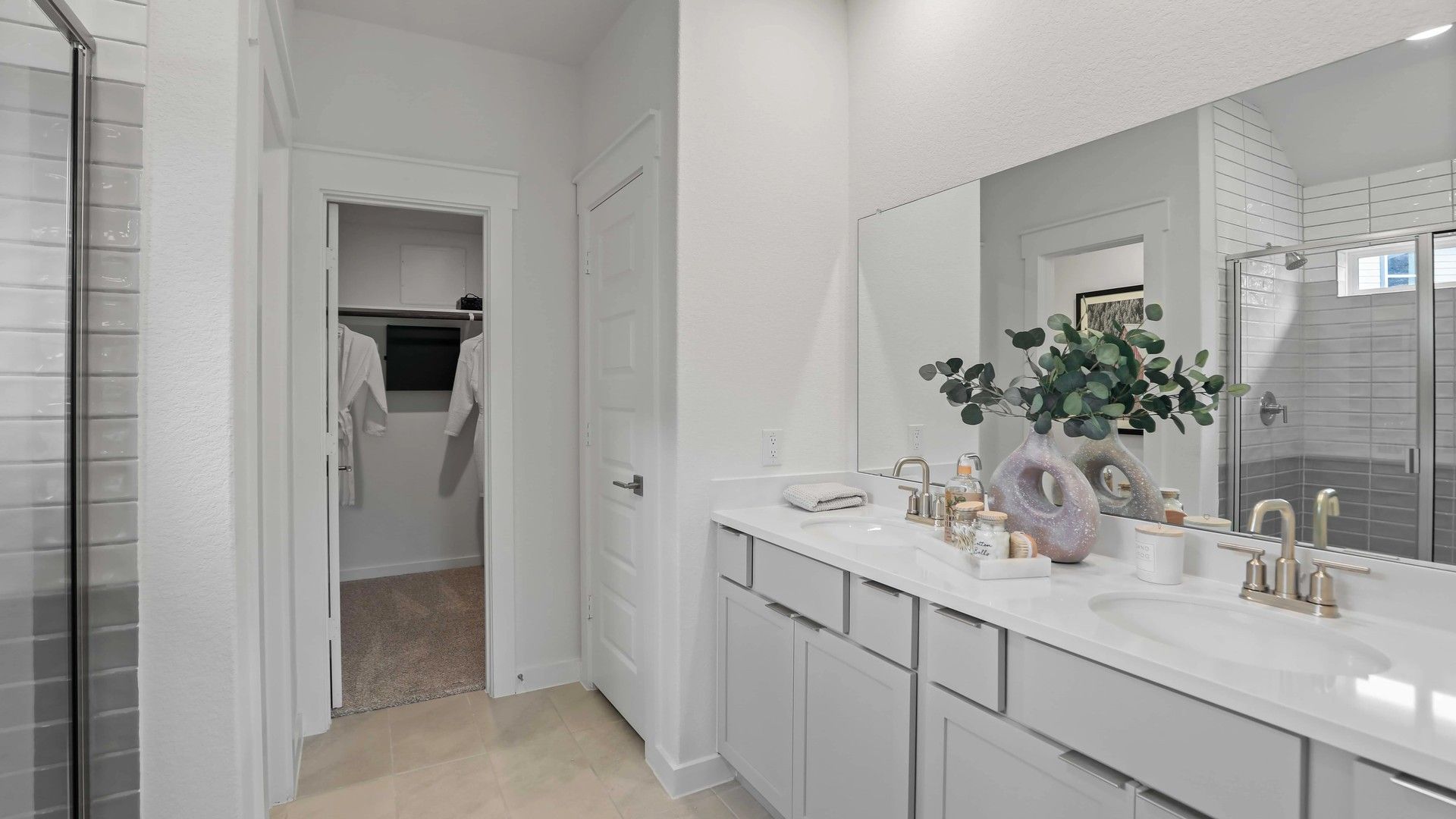Elegant dual sinks and premium fixtures complement this bathroom's refined design in Mostyn Springs.