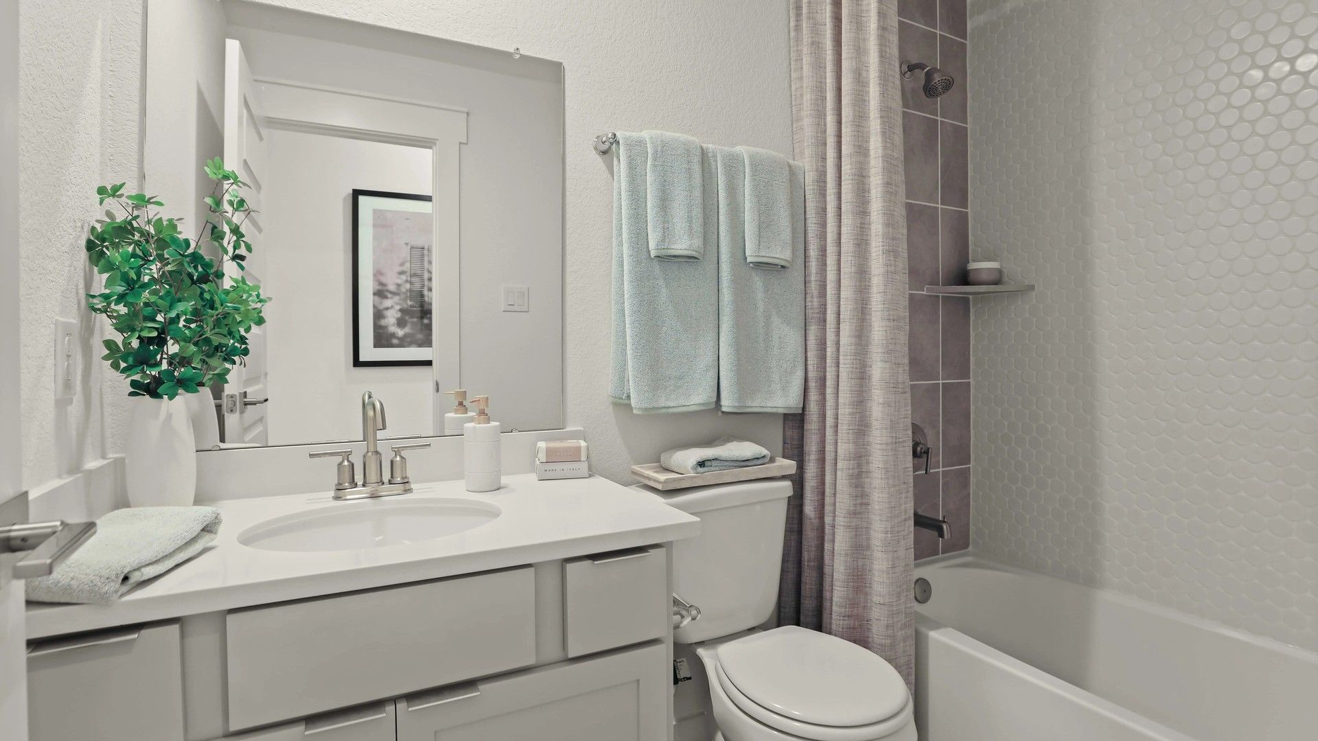 Experience refined elegance with chic white tiles and sleek fixtures in a Mostyn Springs sanctuary.