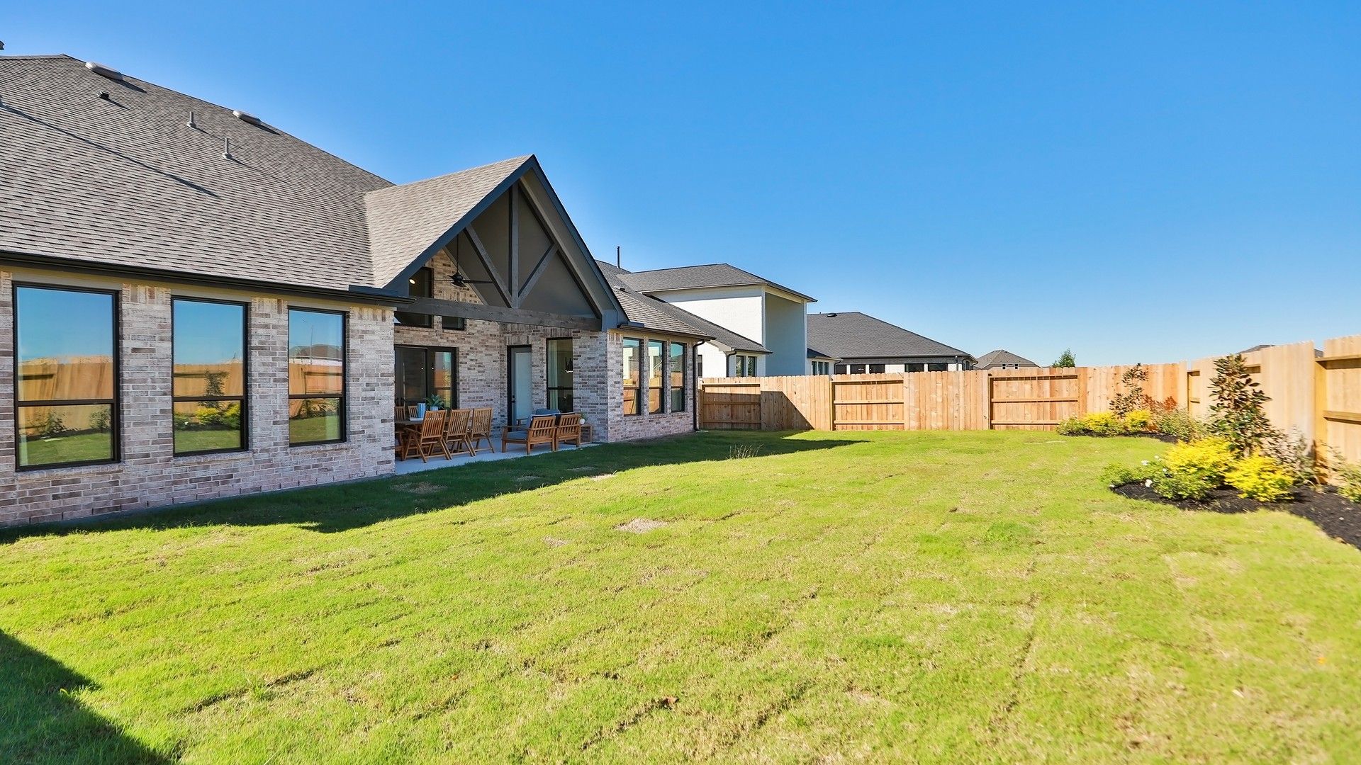 Experience luxury with a gabled roof and expansive yard in Brookewater. Impeccable brickwork defines timeless elegance.