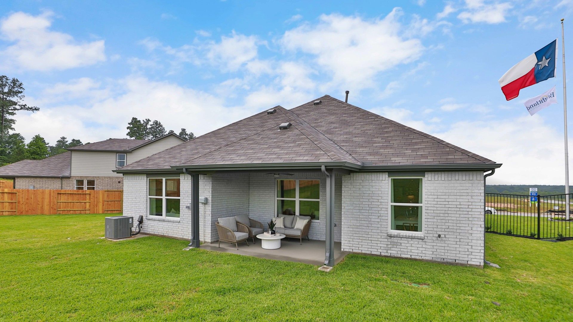 Sophisticated brick exterior with a stylish patio in serene Mostyn Springs, Texas.